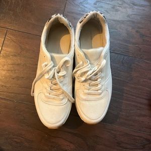 White platform sneakers with snake skin detail